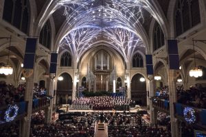 Augsburg's Advent Vespers takes place in the sanctuary of Central Lutheran Church, with choir, orchestra, and packed pews.